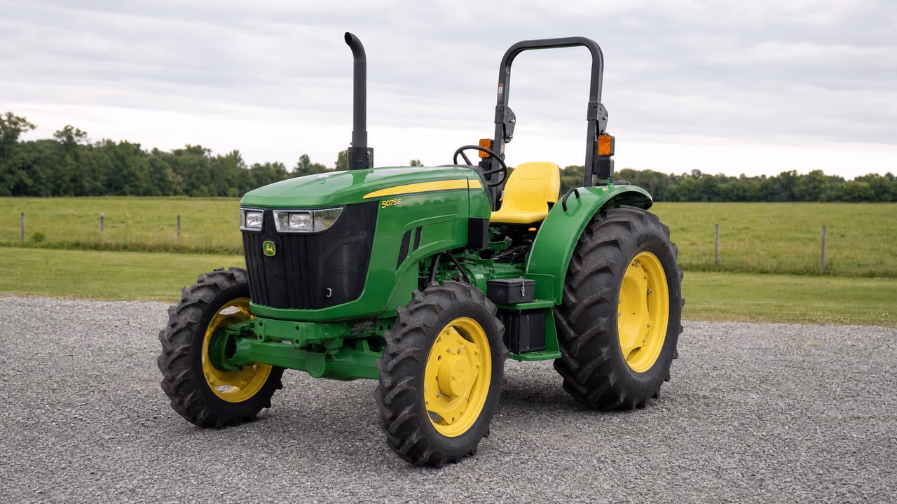 Green John Deere 5075E tractor on a gravel drive.